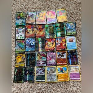Bundle: Pack of Pokémon cards, protective plastics and collectible figures.